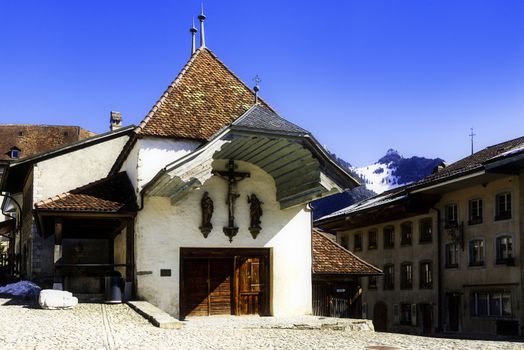 the swiss village Gruyeres with his church in winter