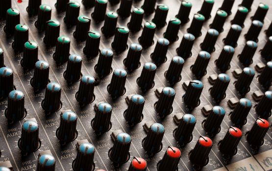 Knobs of a studio soundboard closeup