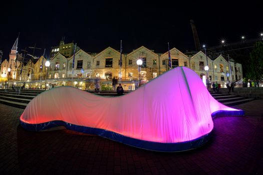 SYDNEY, AUSTRALIA - JUNE 8, 2015; Lux Forma presents the organic form of an elongated wave, illuminated from within by a varying sequence of colour.