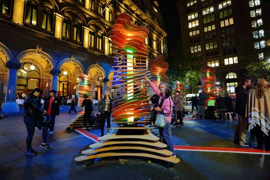SYDNEY, AUSTRALIA - MAY 26, 2013;  Visitors interact with Robotanic in Martin Place, part of Vivid Sydney. When touched light and soothing chimes of nature sound.  Artist:  Thomas Martin / Sebastian Barkoczy