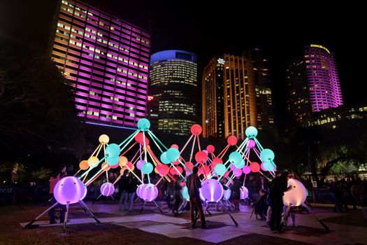 SYDNEY, AUSTRALIA, MAY 27, 2015:  Tourists and local public enjoy the Affinity installation at Vivid Sydney, which  depict the  human brain and neurons.  When touched, the orbs set-up a striking display of sound and light.  People in motion.  Artists:  amigo & amigo (Simone Chua & Renzo B. Larriviere ) + S1T2 (Chris Panzetta & Naimul Khaled)