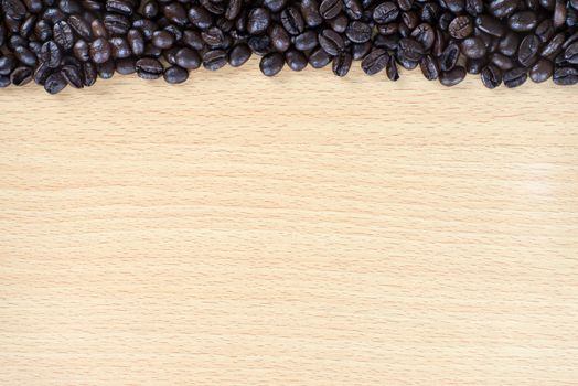 Coffee bean on wood background with space for text