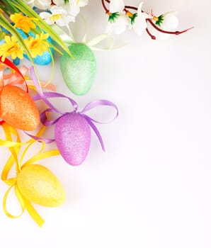 colored easter eggs with flowers on a white background with space for text