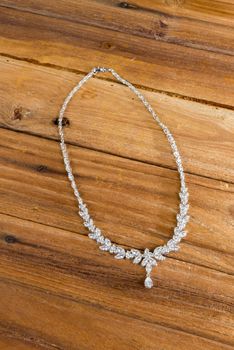 Diamond necklace on wooden table background