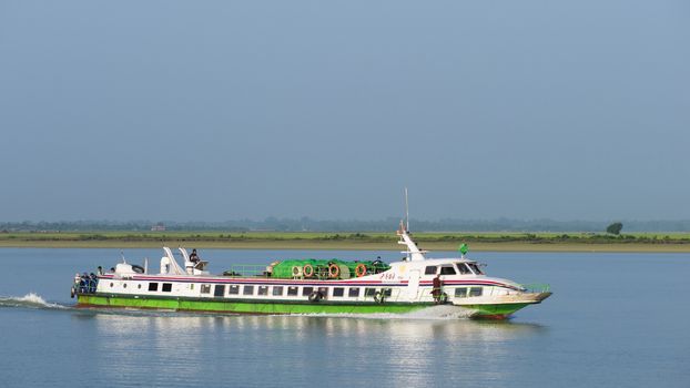 Sittwe, Rakhine State, Myanmar - October 16, 2014: Express boat travelling on the Kaladan River on its way from Sittwe to towns further upstream at the Rakhine State in Myanmar.