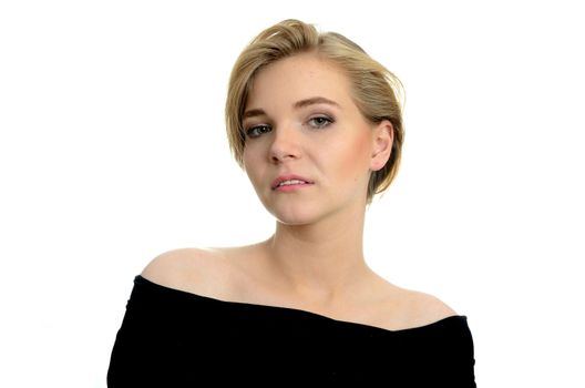 Young girl with kind and soft face expression. Portrait of female model with blond hairs.
