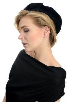 Elegant female model with kind face expression. Young girl with blond hairs, black top and black beret.