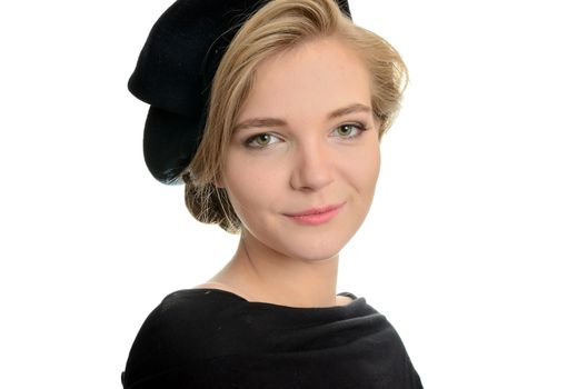 Elegant female model with kind face expression. Young girl with blond hairs, wearing black top and black beret.