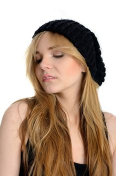 Elegant female model with kind face expression. Young girl with blond hairs and black hat.