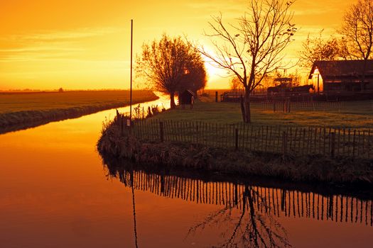 Typical dutch landscape in the countryside from the Netherlands at sunset