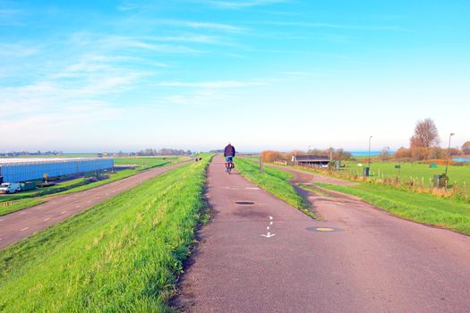 Biking on the dyke near Amsterdam in the Netherlands