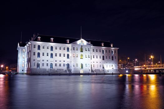 Medieval building in Amsterdam at night in the Netherlands