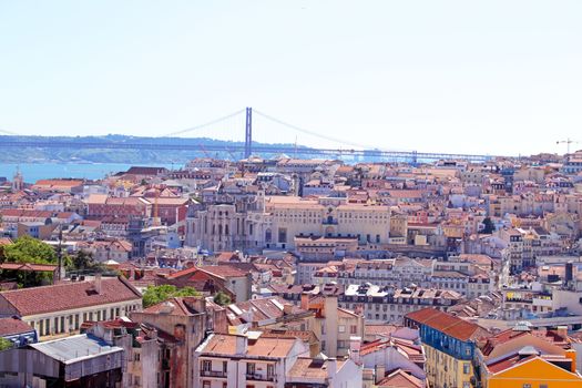 Aerial view with colored houses and the 25 abril bridge in Lisbon Portugal