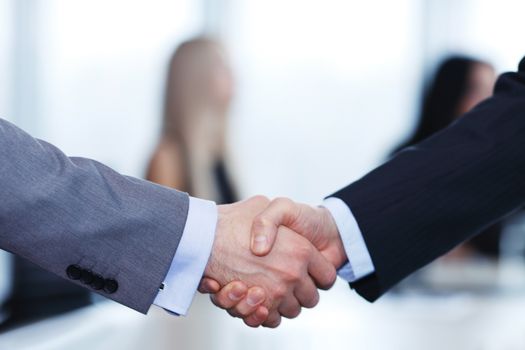 Close-up of handshake of businessmen on meeting in office