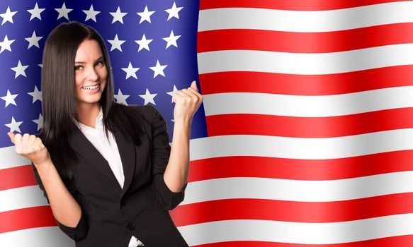 Smiling woman in winner posture on USA flag background