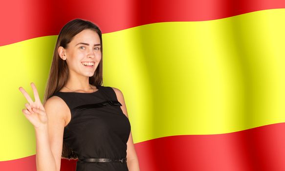 Smiling woman showing peace on Spain flag background