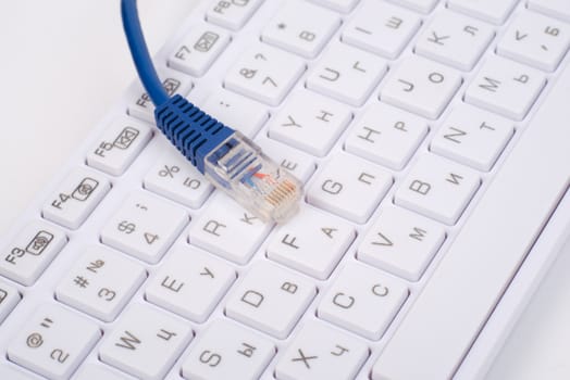 Computer keyboard with blue cable, close up view