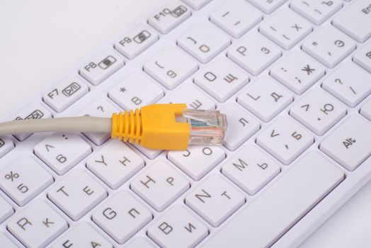 Computer keyboard with yellow cable, top view