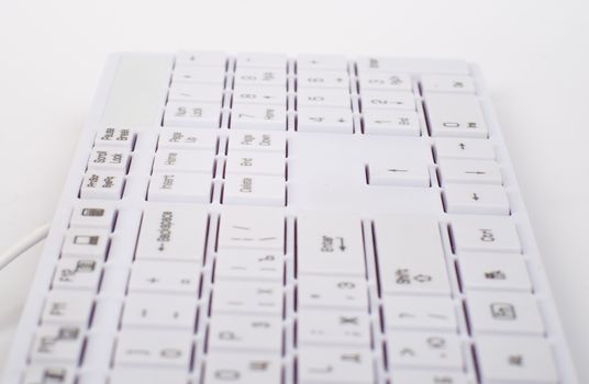 Computer keyboard with wire on isolated white background, close up view