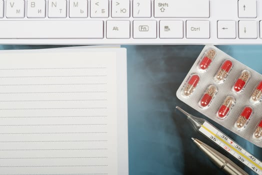 X-ray examination and notebook with thermometer, drugs