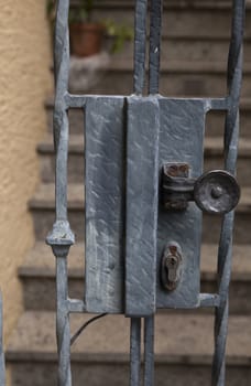 An old lock on a gate to a staircase