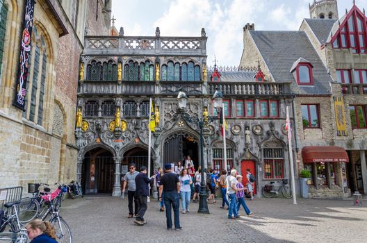 Bruges, Belgium - May 11, 2015: Tourist visit Basilica of the Holy Blood in Bruges, Belgium on May 11, 2015. Basilica is located in the Burg square and consists of a lower and upper chapel.