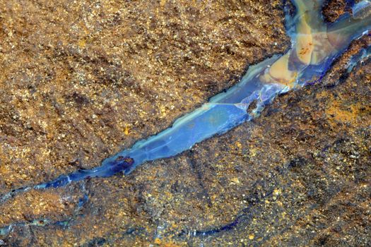 A vein of boulder opal in the host rock. 