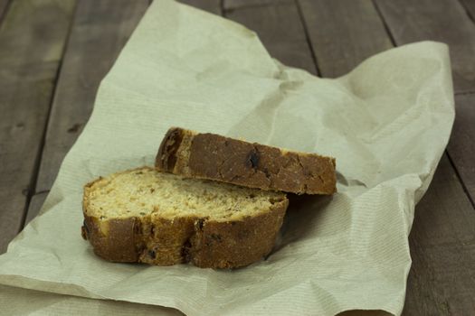 Cut fresh wholemeal bread on a sheet of brown paper