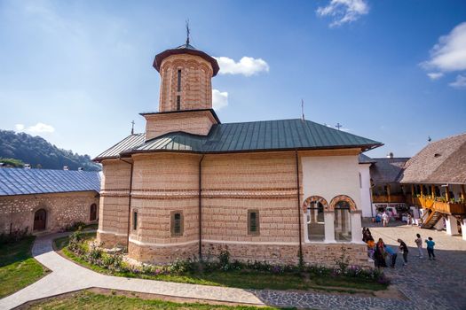 Brasov, Romania - Septemper 9, 2012: Tourists visiting the old orthodox monastery from Polovragi, Romania 