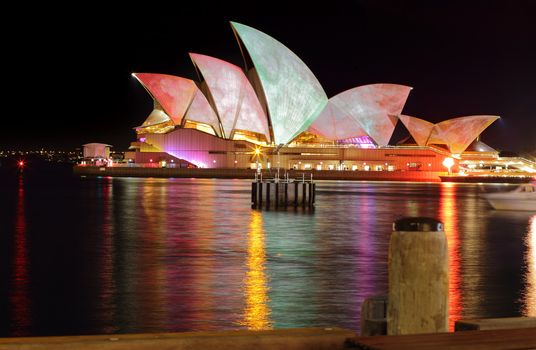 SYDNEY, AUSTRALIA - MAY 27, 2015; The Sydney Opera House during Vivid Sydney annual festival.  Coloured lights and patterns shine on the roof creating a spectacular event, like these watercolours from a long exposure.