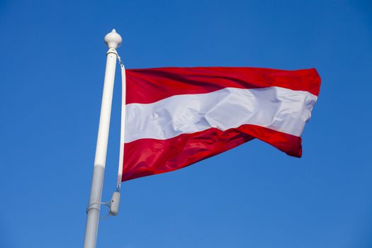 Waving flag of Austria against the blue sky