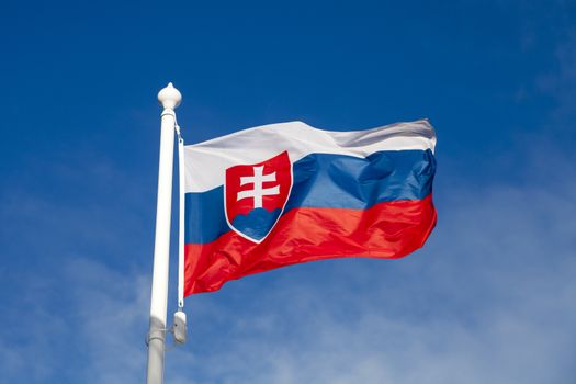 Waving flag of Slovakia against the blue sky