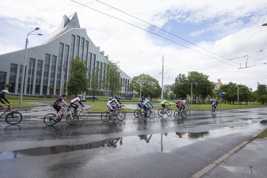 RIGA, LATVIA - MAY 31, 2015: Participants of Riga Cycling Marathon Folk Distance (31.6km) cycling by New Building of National Library of Latvia.