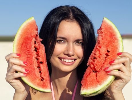 Beautiful happy girl with slice of ripe water-melon