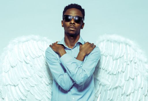 African American young man with angel wings in sunglasses