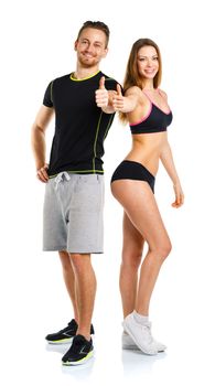 Athletic man and woman after fitness exercise with thumbs up on the white background
