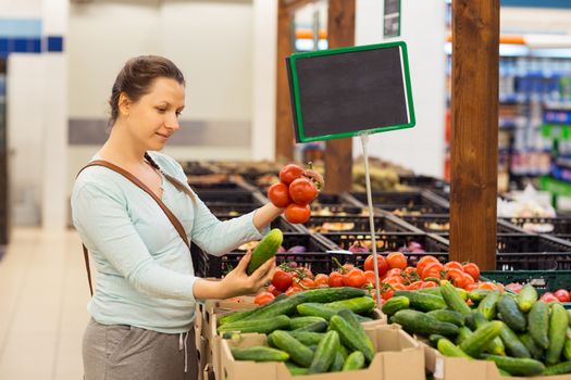 Beautiful young woman shopping for cereal, bulk in a grocery supermarket