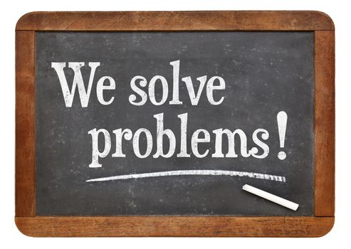 We solve problems  - text on a vintage slate blackboard - service marketing concept