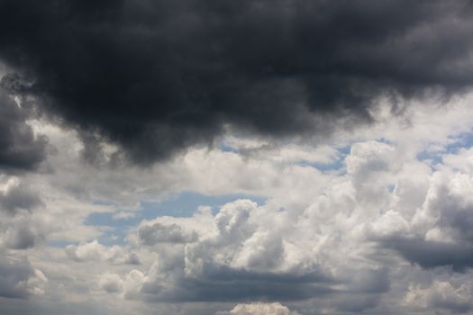 Blue sky being covered over with grey clouds