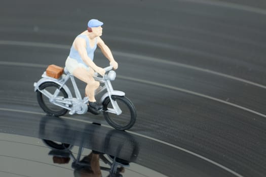 Model people having a cycle race on a record