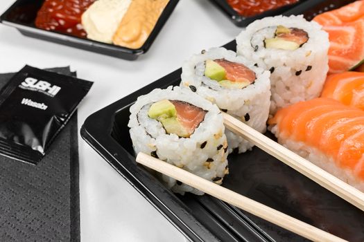 Sushi of rice and salmon with dish and chopsticks