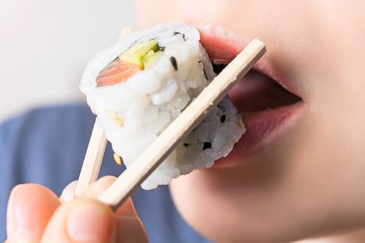 Close-up shot of a person who eats sushi