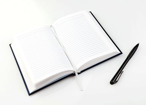 Open notebook with pen on clean sheets