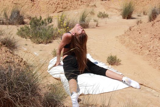 woman doing yoga in the desert