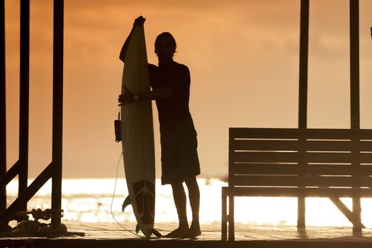 Surfer  with a surfboard at Sunset Tme, Bali, Indonesia
released