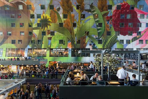 Rotterdam, Netherlands - May 9, 2015: People shopping at Markthal (Market hall) a new icon in Rotterdam. The covered food market and housing development shaped like a giant arch by Dutch architects MVRDV.