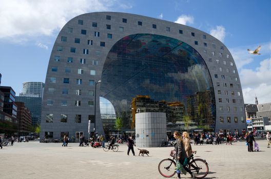 Rotterdam, Netherlands - May 9, 2015: People visit Markthal (Market hall) a new icon in Rotterdam. The covered food market and housing development shaped like a giant arch by Dutch architects MVRDV.