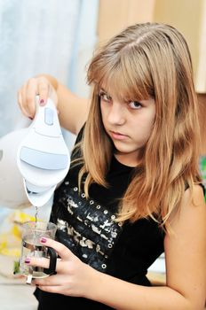 teen girl on the kitchen making tea