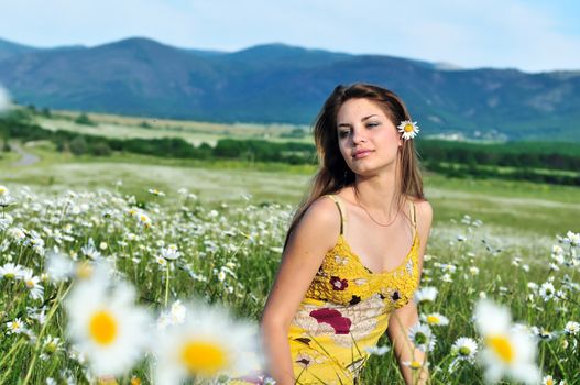 tender girl with daisy flower in hair