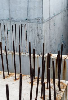 Grey concrete blocks with rusty reinforcing bars